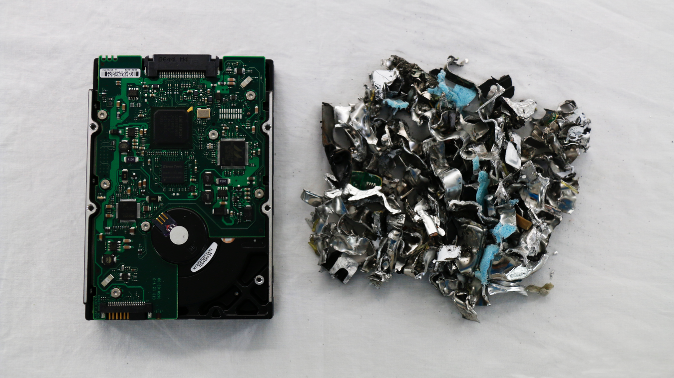 intact hard drive next to shredded hard drive